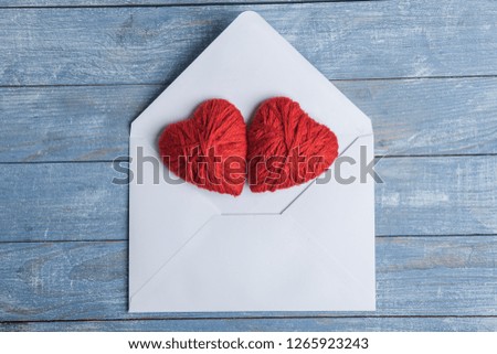 White envelope with hearts on blue background. Valentine's day background. Love concept.
