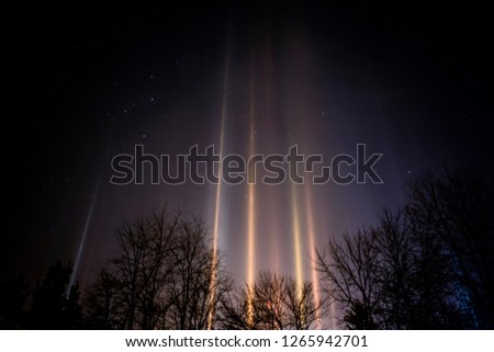 Light Pillars, West Virginia; Light Pillars result from a rare meteorological phenomena that takes place when the humidity is very high, the temperature very low, and there is no wind.  Royalty-Free Stock Photo #1265942701
