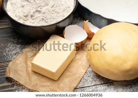 unrolled and unbaked Shortcrust pastry dough recipe on wooden background