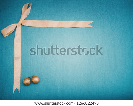 flat lay and minimal object and idea decoration for new year and christmas concept from gold ribbon bow and ornament ball arrange on green shades texture background