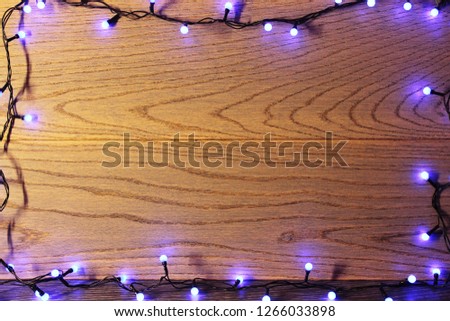 abstract lights background. garland on the wooden background
