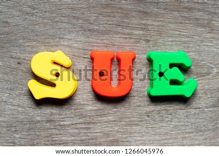 Color alphabet letter in word sue on wood background