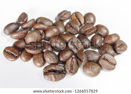 Well-stocked coffee beans on a white background close-up.