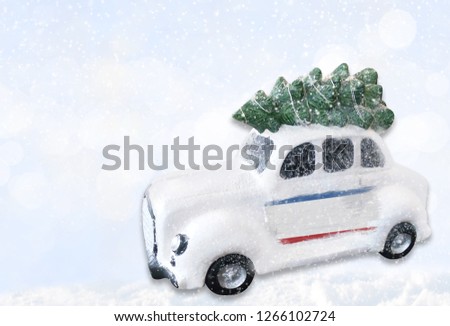 A miniature white Christmas car with a flag of Crimea.