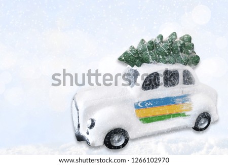 A miniature white Christmas car with a flag of Karakalpakstan.