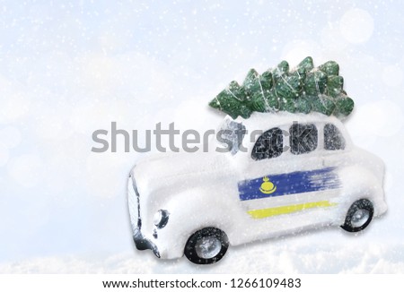 A miniature white Christmas car with a flag of Buryatia.