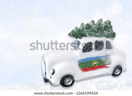 A miniature white Christmas car with a flag of Karachay Cherkessia.