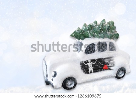 A miniature white Christmas car with a flag of Blackbeard Pirate.