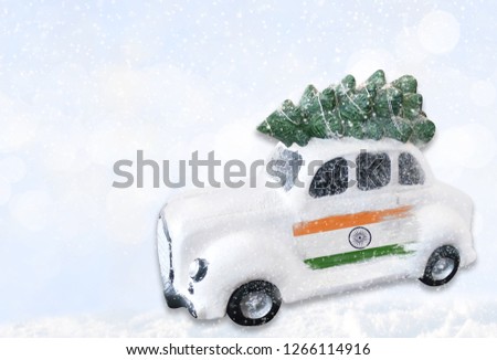 A miniature white Christmas car with a flag of India.