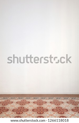 White room wall and ancient tiled floor in a renovated interior