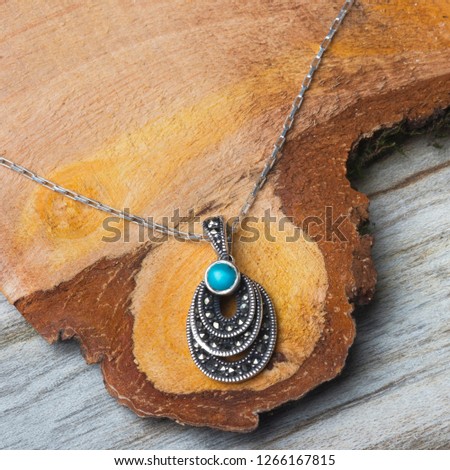 
An Emerald Necklace on Wood