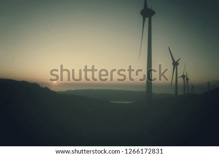 Renewable energies, wind turbines are high up in the mountains, turning wind power into electricity, while offering a unique spectacle with their silhouettes on the tops and giving unique images .