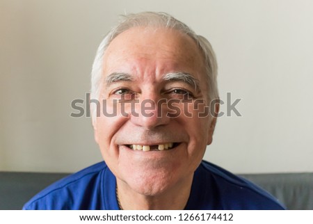 old man senior face closeup missing tooth smile proper  dental care insurance health Royalty-Free Stock Photo #1266174412