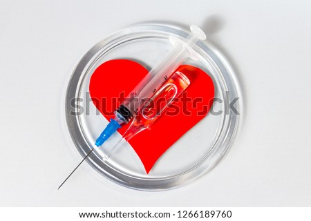 Heart, ampoule with medicine and the syringe for injections