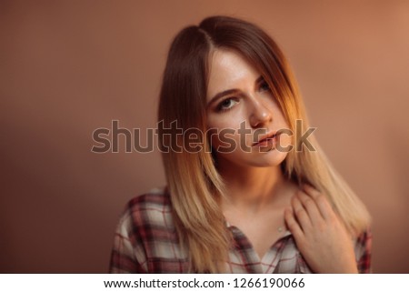 portrait smiling girl on orange background in studio.