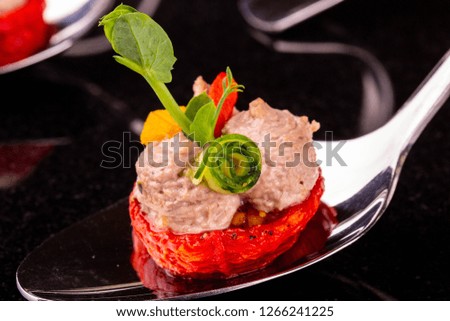 Guinea fowl paste on a dried tomato with a cucumber and greens