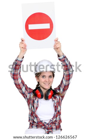 Worker holding warning sign