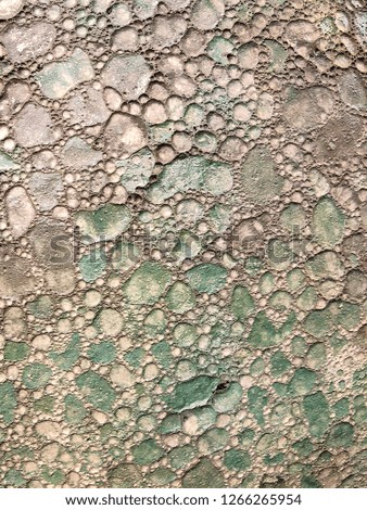 An earthly, stone surface with crakled texture photographed in macro view to form an artistic and decorative background 
