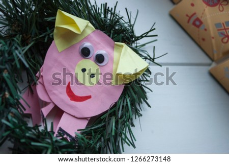 The mascot of 2019 is a pig on a white and bright background. Happy New Year and Merry Christmas with Pig
