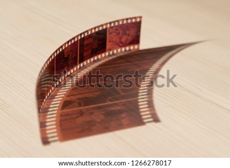 35 mm negative colored film frame or border on the table with shadow