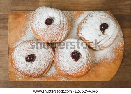 Food for hanukkah is jelly doughnuts with sugar powder.
