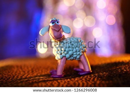 merry plasticine sheep from the Christmas series on a blurred background