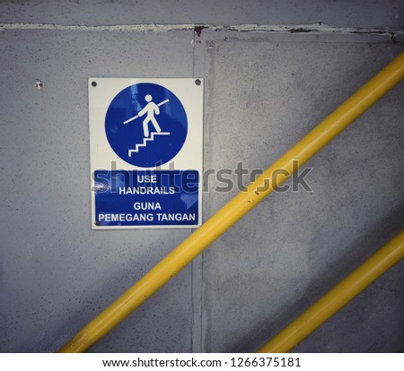 Sign Use Handrails on the wall. 