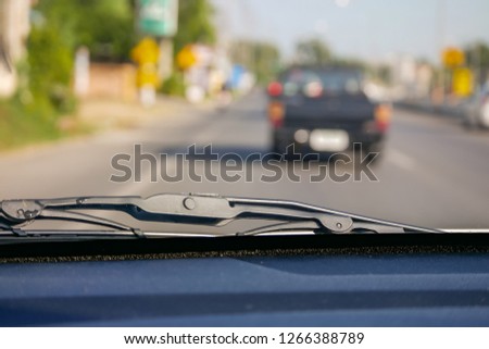 The car dashboard with the front window blur vision view. 