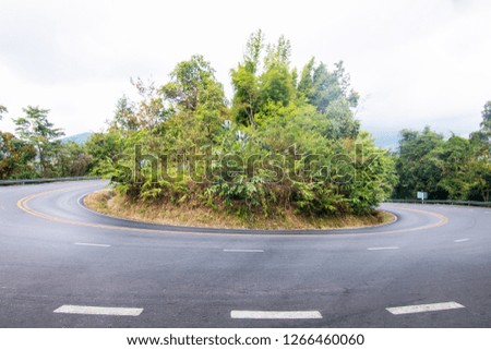 The road curves up the mountain. The road up to Doi Suthep. Dangerous curved path.