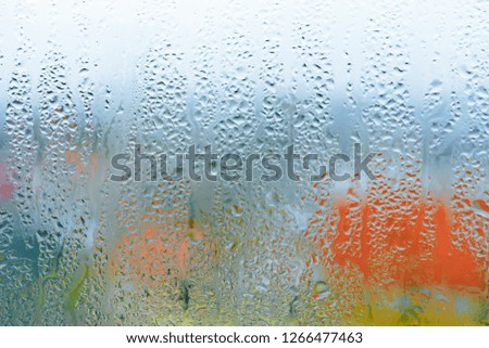 Natural water drop background, window glass with condensation humidity, large droplets flow down. Collecting and streaming down 