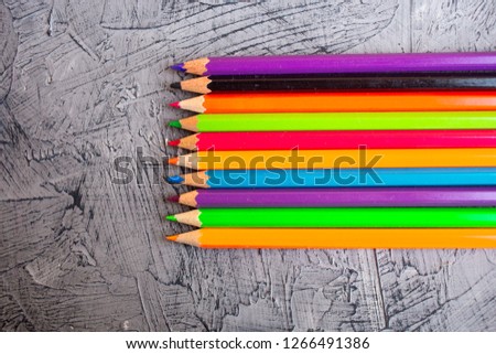 Color pencils on gray concrete background