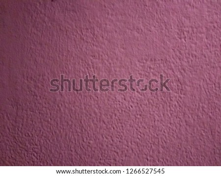 The surface of the plaster wall is painted purple mixed with white.