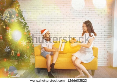 
Holidays and happy family concepts : Brother and sister in the family Cheerful, giving a gift box to each other
