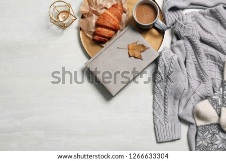 Flat lay composition with warm sweater and space for text on light background