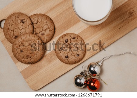 Cookie with milk on the table for Santa Claus.