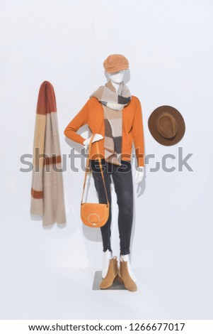 female sweater clothing with black pants ,hat , ,boots shoes,scarf on full mannequin 
