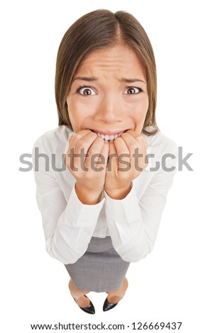 Frightened and stressed young business woman biting her fingers, high angle Royalty-Free Stock Photo #126669437