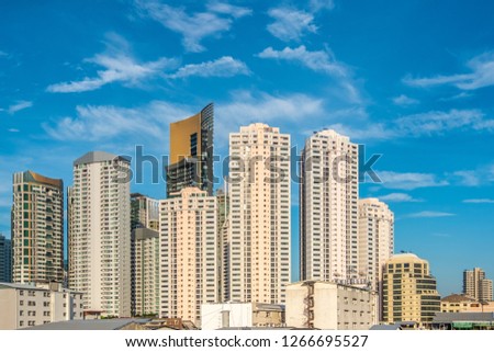 Business district with high building at sunshine day in Bangkok. Condominium in Bangkok city downtown with blue sky.