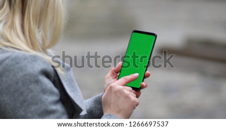 Close-up of female hands using smart phone. woman typing text message on her cellphone.