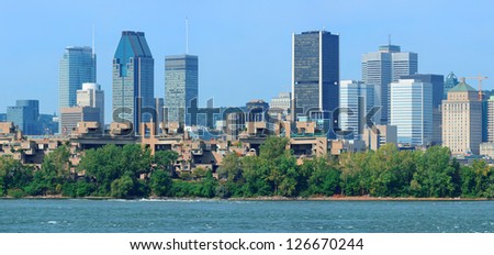Montreal city skyline panorama over river in the day with urban buildings