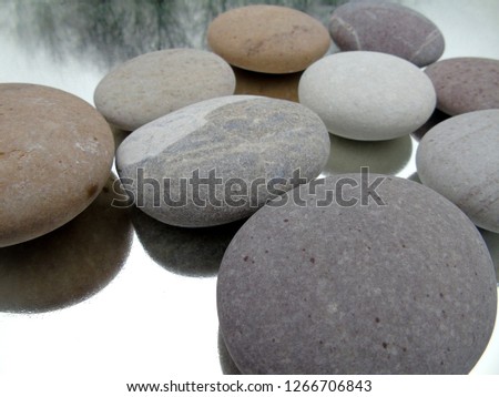          smooth beach pebbles with reflections                      