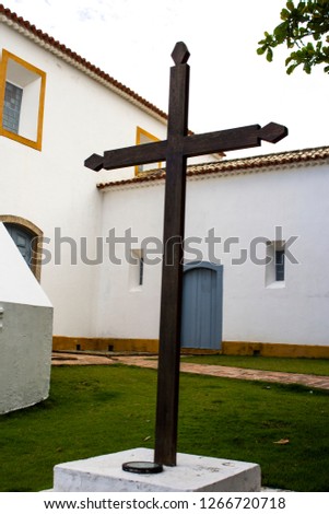Wooden cross. Wooden cross with church architecture in the background.