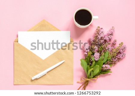 Bouquet of pink flowers, envelope with white blank card for text and cup of coffee on pink background Greeting card Flat Lay Mock up Concept Good morning or Womens day.