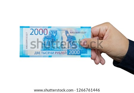 2000 rubles in male hand on white background. isolated object. Hand giving banknotes in financial, money exchange and donation concepts.