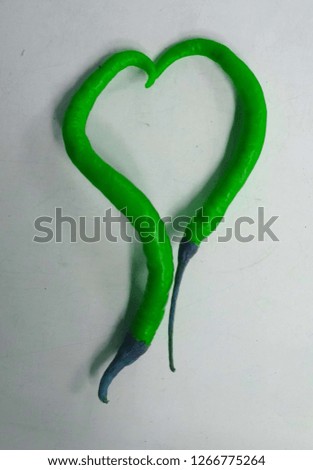 heart shaped green chili with a white background for your love text - Image