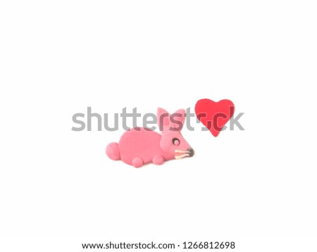 Cute rabbit with heart made from plasticine clay on white background, lovely animal are dough