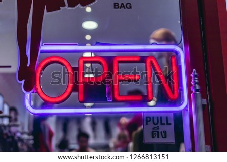 Neon open sign board in the thailand shop.