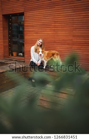 portrair of girl cuddle red and white cute dog border collie