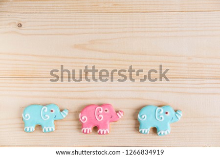 Photos of cars and elephants on a wooden background. Children banner. Frame for greeting card newborn boy. Blank for design childish banner with gingerbread.