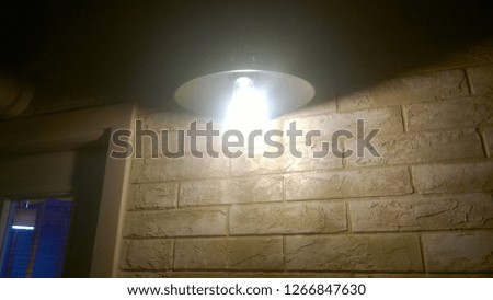 Texture, background, wallpaper of bright light of a lamp in a closed public or living room, resembling a full moon.